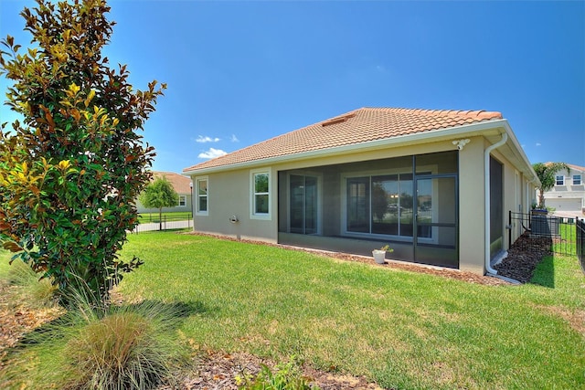1101 Downswing Pl, Davenport, FL 33896 - back of house with a tiled roof, stucco siding, and a sunroom