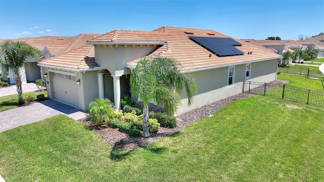 1101 Downswing Pl, Davenport, FL 33896 - view of front facade with stucco siding, roof mounted solar panels, driveway, and a garage