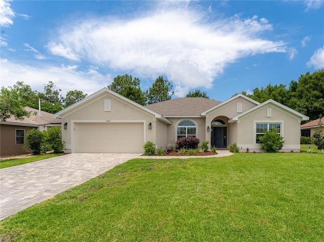 6644 SW 179th Court Rd, Dunnellon, FL 34432 - ranch-style house with stucco siding, decorative driveway, a front yard, and an attached garage