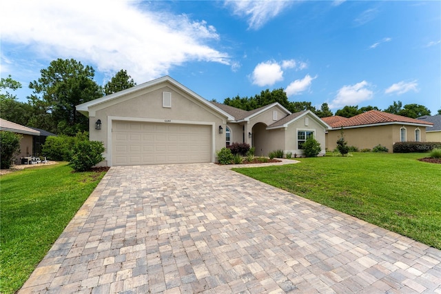 6644 SW 179th Court Rd, Dunnellon, FL 34432 - single story home featuring decorative driveway, stucco siding, and a front lawn