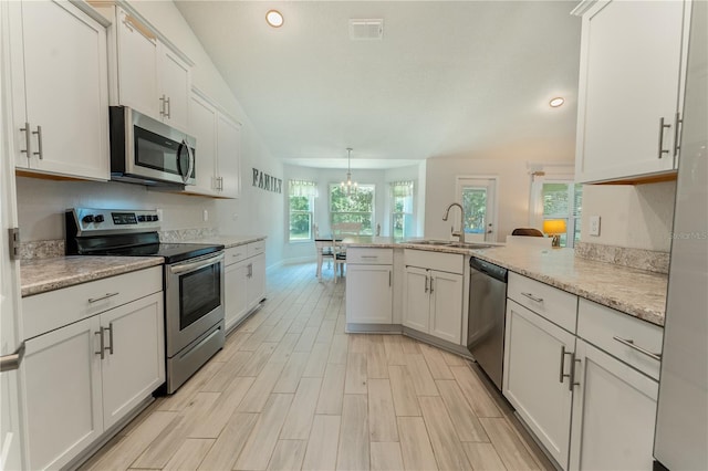 6644 SW 179th Court Rd, Dunnellon, FL 34432 - kitchen featuring appliances with stainless steel finishes, a sink, a peninsula, recessed lighting, and white cabinets