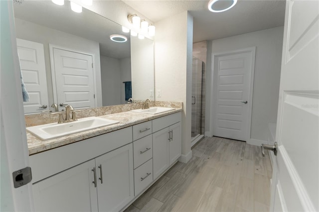 6644 SW 179th Court Rd, Dunnellon, FL 34432 - full bath with double vanity, a shower stall, wood finished floors, and baseboards