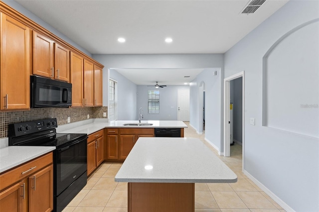 13636 Beauregard Pl, Orlando, FL 32837 - kitchen featuring black appliances, a sink, a peninsula, light countertops, and a ceiling fan