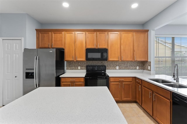 13636 Beauregard Pl, Orlando, FL 32837 - kitchen featuring black appliances, a sink, decorative backsplash, recessed lighting, and brown cabinetry