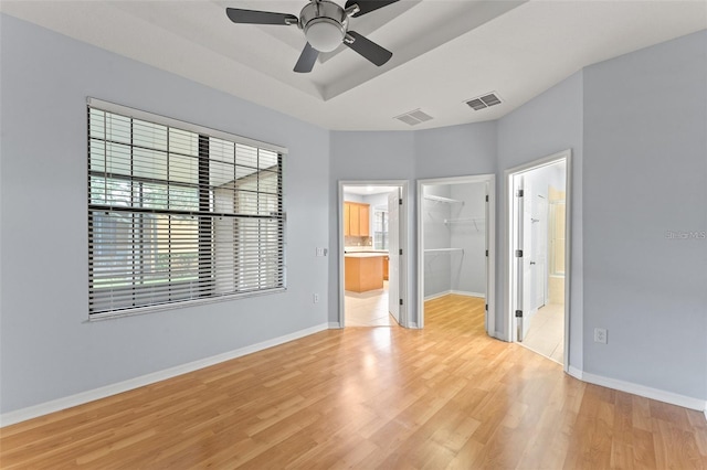 13636 Beauregard Pl, Orlando, FL 32837 - unfurnished bedroom featuring a spacious closet, light wood-style floors, baseboards, ensuite bath, and a closet