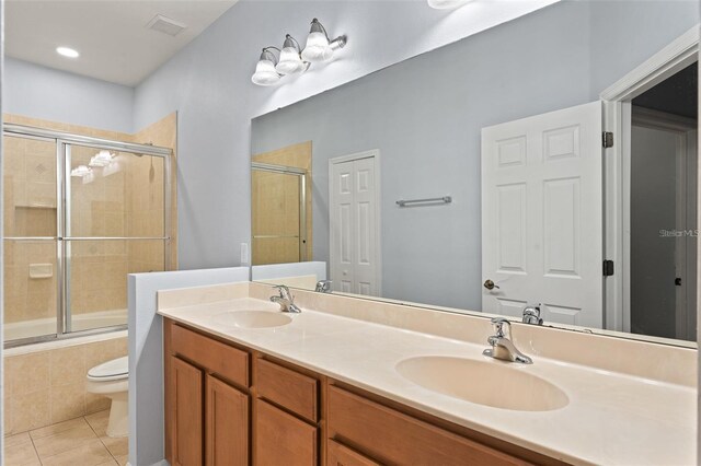 13636 Beauregard Pl, Orlando, FL 32837 - full bathroom with tile patterned floors, toilet, tiled shower / bath, and double vanity