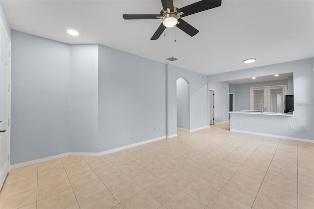 13636 Beauregard Pl, Orlando, FL 32837 - unfurnished room featuring light tile patterned floors, a ceiling fan, recessed lighting, a sink, and arched walkways