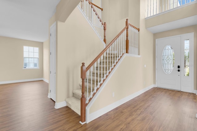 2255 Stone Lake Ct, Orlando, FL 32824 - foyer entrance featuring wood finished floors, stairway, and a towering ceiling