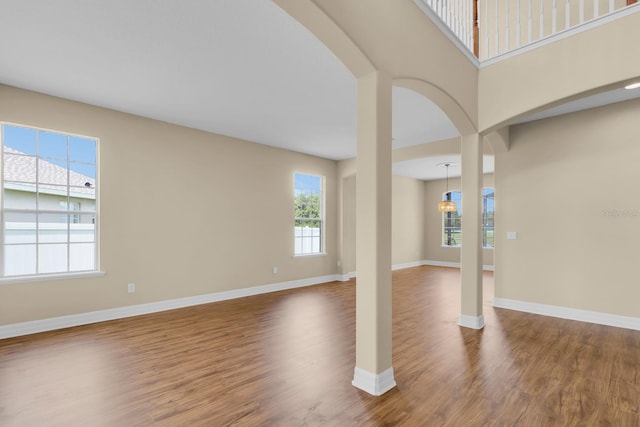 2255 Stone Lake Ct, Orlando, FL 32824 - unfurnished room featuring healthy amount of natural light, wood finished floors, and arched walkways