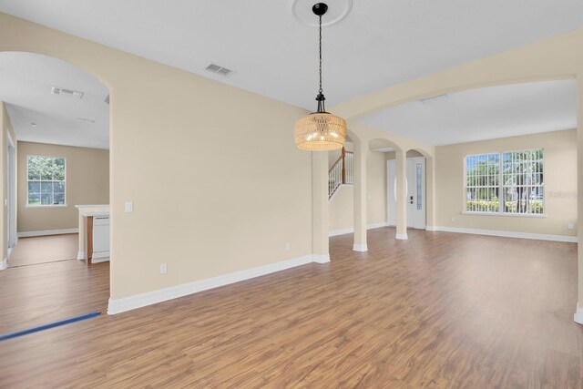 2255 Stone Lake Ct, Orlando, FL 32824 - unfurnished living room featuring arched walkways and light wood-style flooring