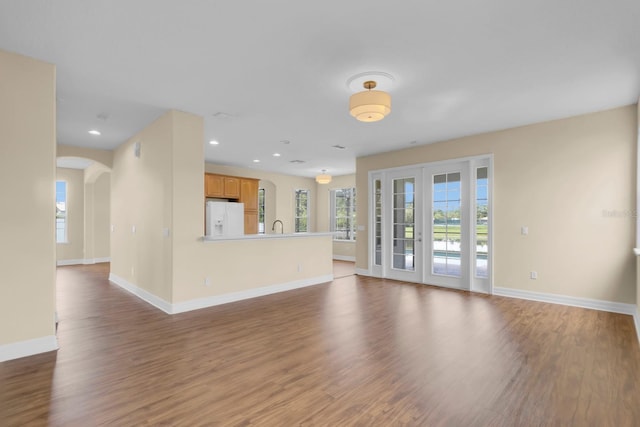 2255 Stone Lake Ct, Orlando, FL 32824 - unfurnished living room featuring wood finished floors, arched walkways, and recessed lighting