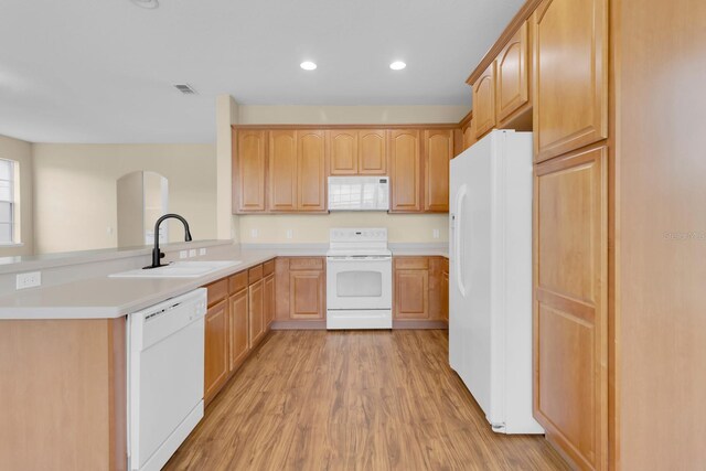 2255 Stone Lake Ct, Orlando, FL 32824 - kitchen with white appliances, a peninsula, light wood-style floors, light brown cabinetry, and recessed lighting