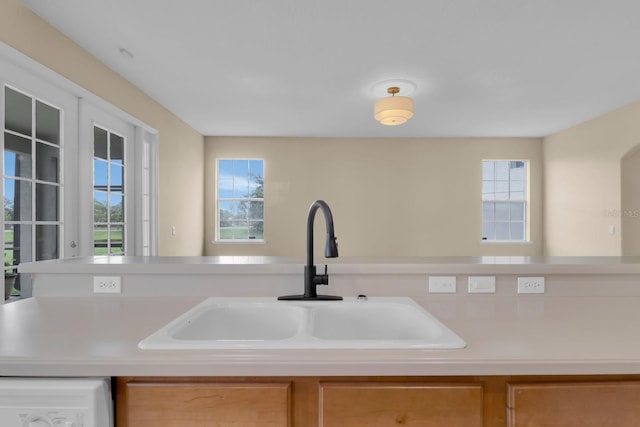 2255 Stone Lake Ct, Orlando, FL 32824 - kitchen featuring plenty of natural light, washer / clothes dryer, and light countertops
