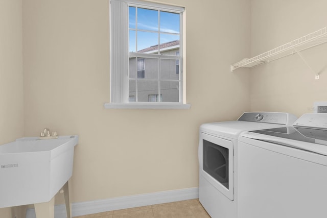 2255 Stone Lake Ct, Orlando, FL 32824 - washroom with washer and dryer and light tile patterned flooring