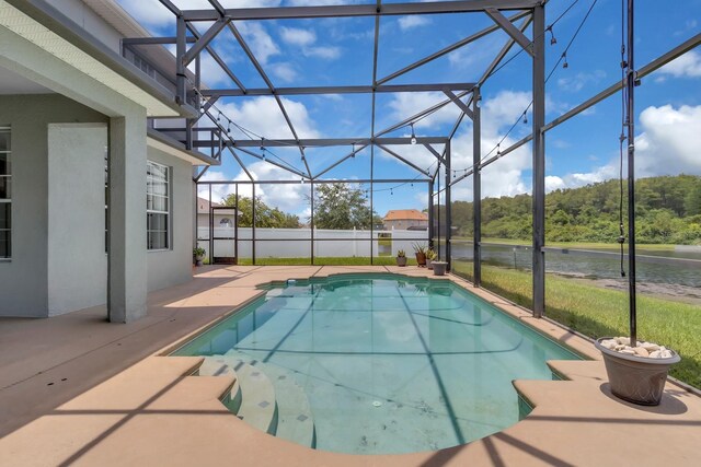 2255 Stone Lake Ct, Orlando, FL 32824 - view of swimming pool with a patio area, glass enclosure, and a water view