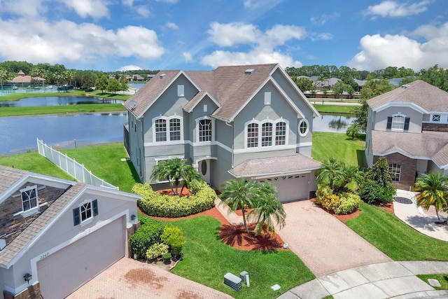 2255 Stone Lake Ct, Orlando, FL 32824 - view of front of home featuring decorative driveway, a water view, stucco siding, and an attached garage