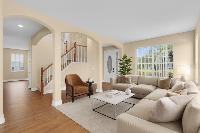 2255 Stone Lake Ct, Orlando, FL 32824 - living room featuring wood finished floors, plenty of natural light, stairway, arched walkways, and recessed lighting