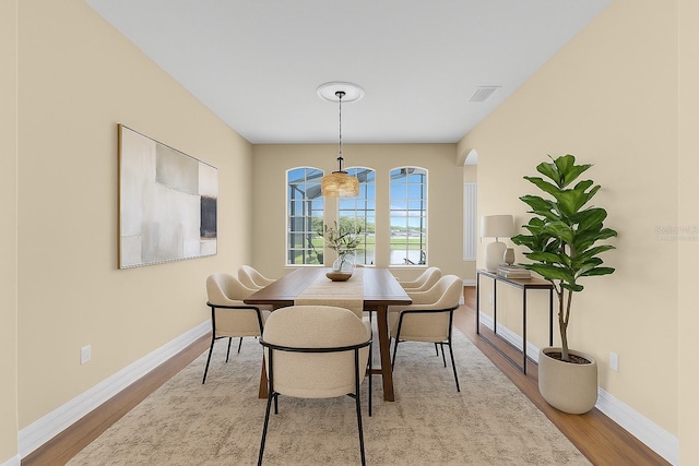 2255 Stone Lake Ct, Orlando, FL 32824 - dining area featuring wood finished floors and arched walkways