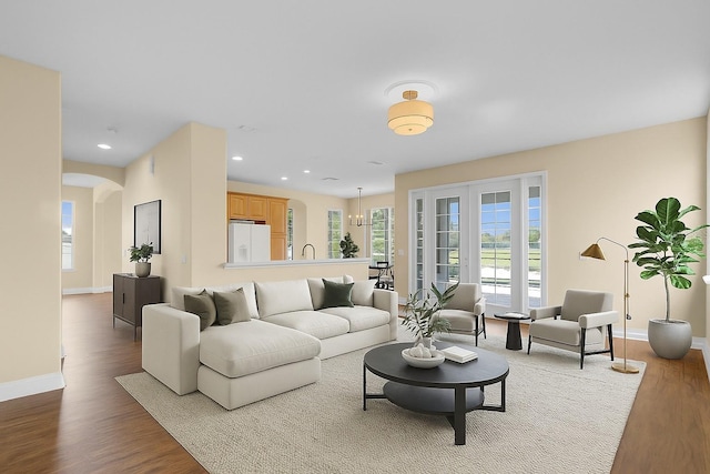 2255 Stone Lake Ct, Orlando, FL 32824 - living room with wood finished floors, arched walkways, and recessed lighting