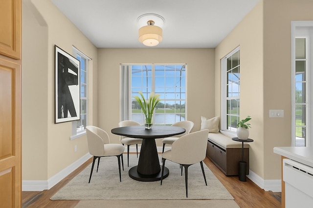 2255 Stone Lake Ct, Orlando, FL 32824 - dining room with light wood finished floors and a water view