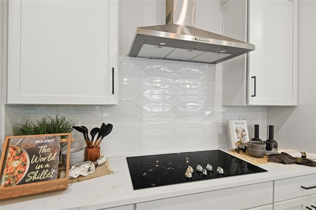 224 Thornberry Way, Palm Coast, FL 32164 - kitchen with wall chimney exhaust hood, black electric stovetop, tasteful backsplash, and white cabinetry