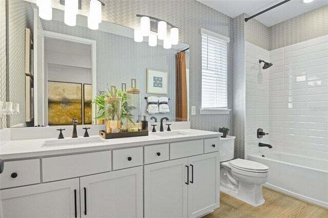 224 Thornberry Way, Palm Coast, FL 32164 - full bathroom with wood finished floors, double vanity, toilet, healthy amount of natural light, and wallpapered walls
