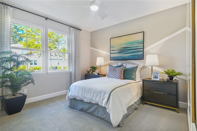 217 Thornberry Way, Palm Coast, FL 32164 - carpeted bedroom with multiple windows, baseboards, and a ceiling fan