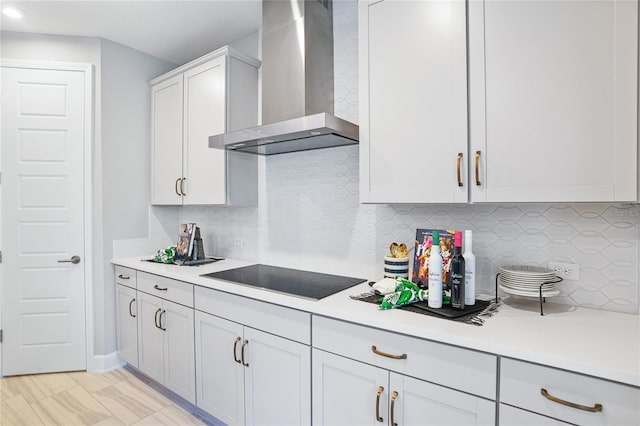 230 Thornberry Way, Palm Coast, FL 32164 - kitchen with wall chimney range hood, black electric cooktop, light countertops, decorative backsplash, and white cabinetry