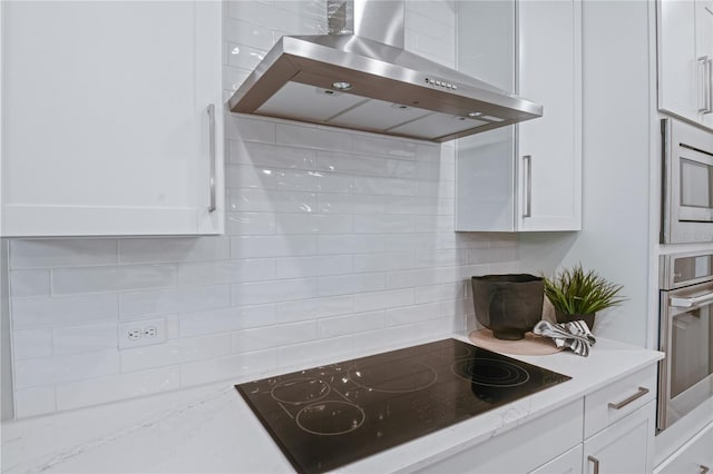 212 Thornberry Way, Palm Coast, FL 32164 - kitchen featuring wall chimney exhaust hood, appliances with stainless steel finishes, backsplash, and white cabinetry