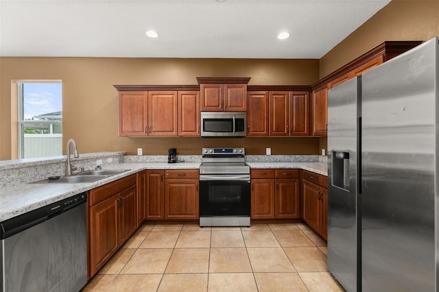 326 Highland Meadows Ave, Davenport, FL 33837 - kitchen with stainless steel appliances, a sink, light countertops, light tile patterned flooring, and brown cabinets