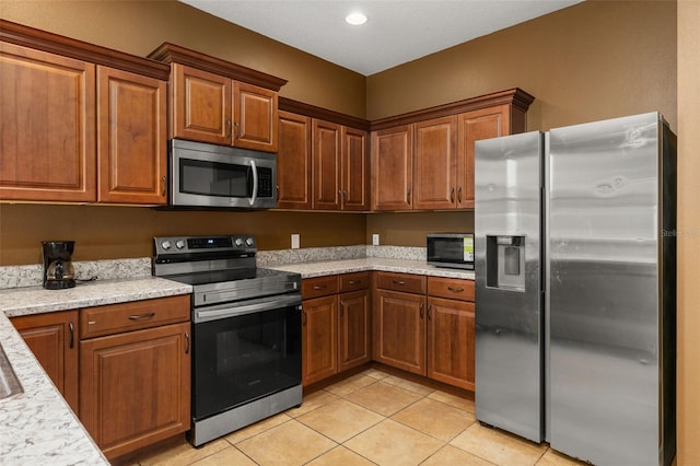 326 Highland Meadows Ave, Davenport, FL 33837 - kitchen featuring stainless steel appliances, light tile patterned floors, brown cabinetry, and recessed lighting