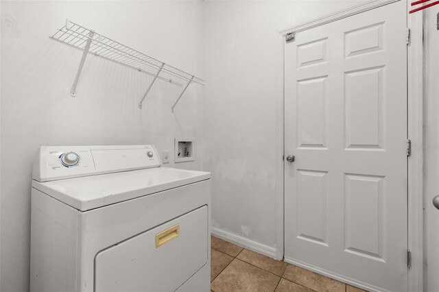 326 Highland Meadows Ave, Davenport, FL 33837 - laundry area featuring washer / clothes dryer, light tile patterned floors, and baseboards