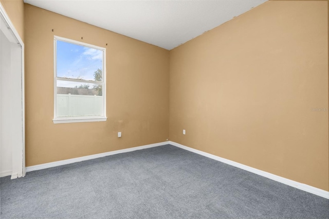 326 Highland Meadows Ave, Davenport, FL 33837 - empty room featuring dark colored carpet and baseboards