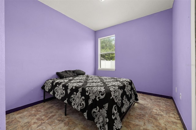 326 Highland Meadows Ave, Davenport, FL 33837 - bedroom with baseboards and stone finish floors