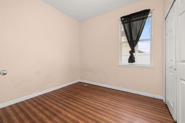 326 Highland Meadows Ave, Davenport, FL 33837 - unfurnished bedroom featuring baseboards, dark wood-type flooring, and a closet