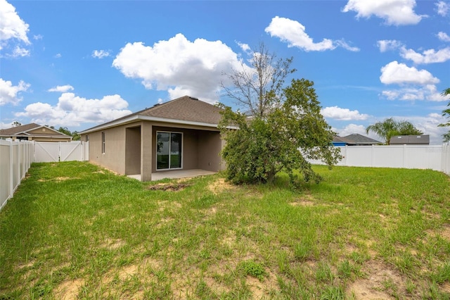 326 Highland Meadows Ave, Davenport, FL 33837 - back of property featuring stucco siding, a patio area, and a gate