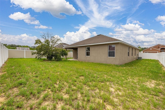 326 Highland Meadows Ave, Davenport, FL 33837 - back of house with stucco siding and central AC