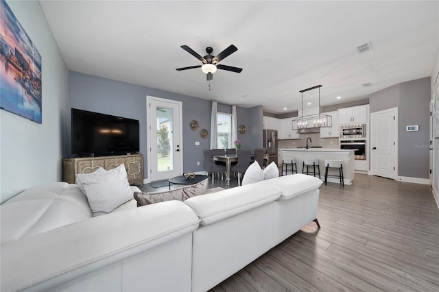 1335 Greenfield Loop, Kissimmee, FL 34747 - living area with light wood-style flooring, a ceiling fan, recessed lighting, and baseboards