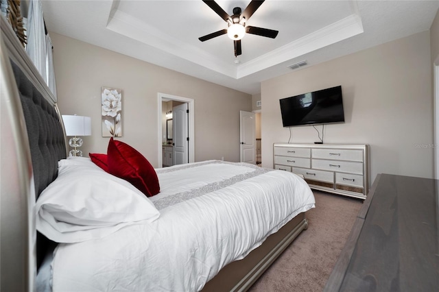 1335 Greenfield Loop, Kissimmee, FL 34747 - carpeted bedroom with a raised ceiling, a ceiling fan, and ensuite bath