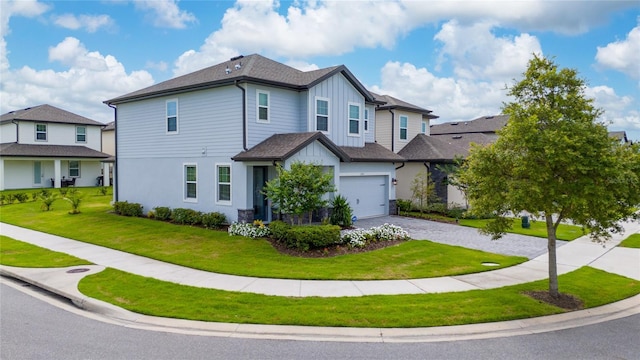1335 Greenfield Loop, Kissimmee, FL 34747 - view of front of property with board and batten siding, decorative driveway, a front lawn, and a shingled roof