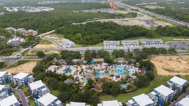 1335 Greenfield Loop, Kissimmee, FL 34747 - view of property location featuring a heavily wooded area and a pool