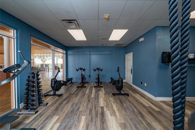 1335 Greenfield Loop, Kissimmee, FL 34747 - exercise area with a drop ceiling, wood finished floors, and baseboards