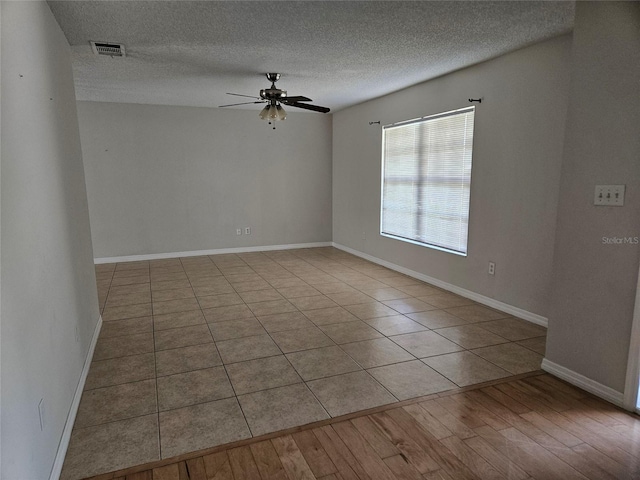 2805 Rodeo Dr, Kissimmee, FL 34746 - spare room with ceiling fan, a textured ceiling, baseboards, and wood finished floors