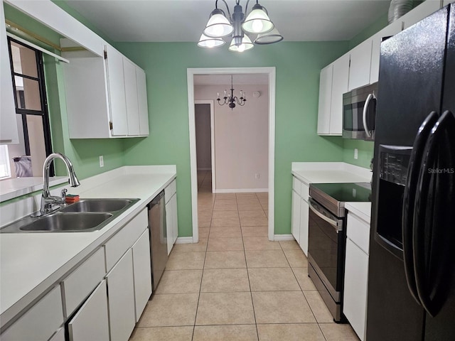 2805 Rodeo Dr, Kissimmee, FL 34746 - kitchen featuring appliances with stainless steel finishes, a chandelier, a sink, light tile patterned floors, and light countertops