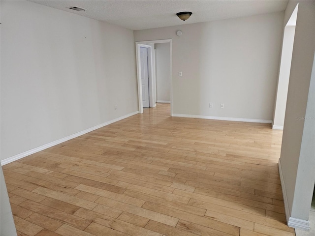 2805 Rodeo Dr, Kissimmee, FL 34746 - spare room with light wood finished floors, a textured ceiling, and baseboards