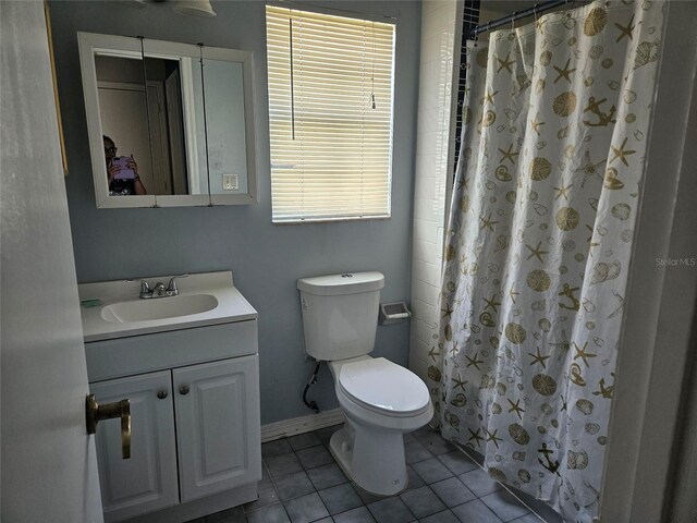 2805 Rodeo Dr, Kissimmee, FL 34746 - bathroom with vanity, toilet, tile patterned flooring, baseboards, and a shower with curtain