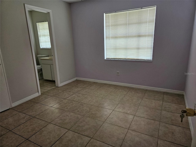 2805 Rodeo Dr, Kissimmee, FL 34746 - tiled spare room featuring baseboards