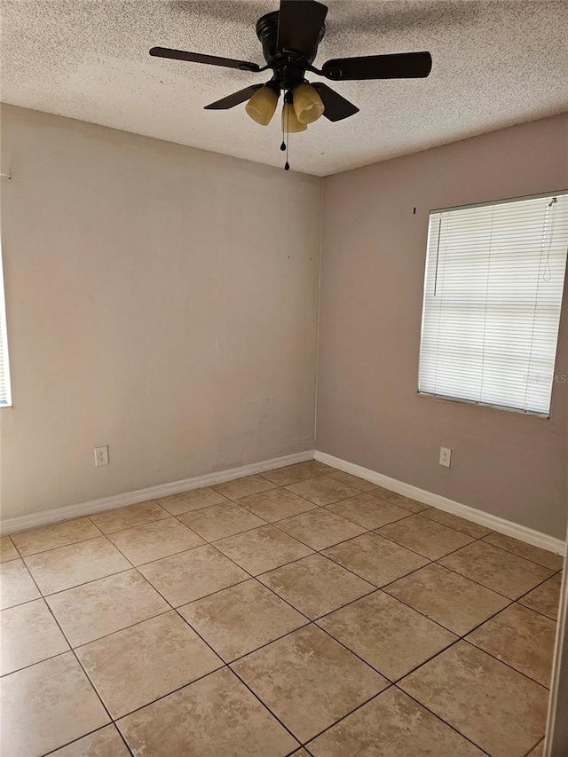 2805 Rodeo Dr, Kissimmee, FL 34746 - spare room with a textured ceiling, light tile patterned floors, ceiling fan, and baseboards