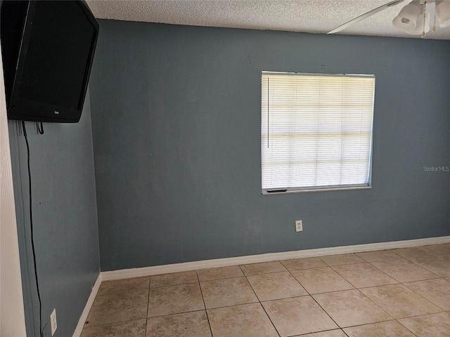 2805 Rodeo Dr, Kissimmee, FL 34746 - unfurnished room featuring ceiling fan, light tile patterned floors, baseboards, and a textured ceiling