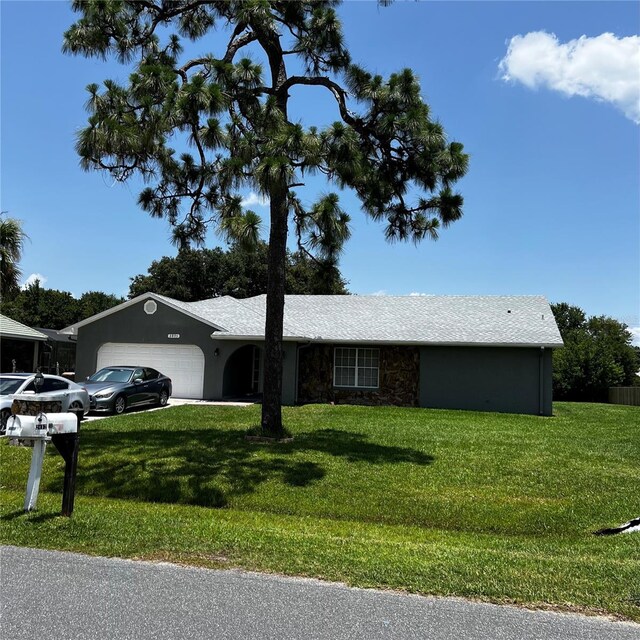 2805 Rodeo Dr, Kissimmee, FL 34746 - single story home with a garage, a front lawn, and stone siding